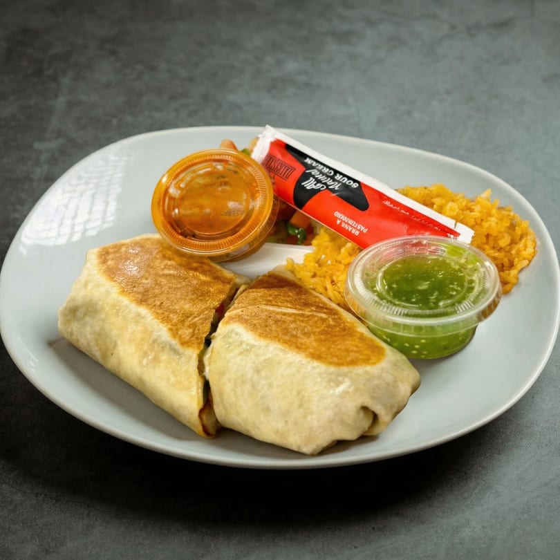 Mucho Loco Mexican Restaurant's burrito, rice, salsa, and sour cream on a white plate.